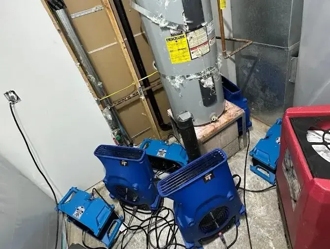 Air movers beside an opened water heater closet